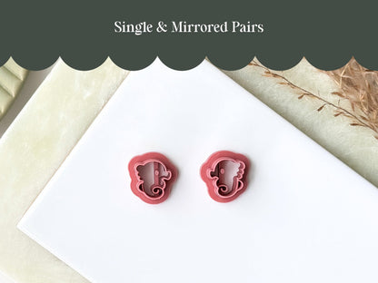 A pair of mirrored seahorse clay cutters for making polymer clay earrings or fondant decorations.