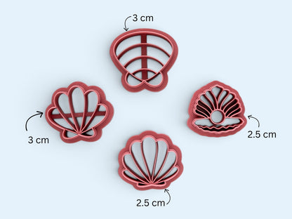 Fourpink seashell-shaped clay cutters arranged on a light blue background, with size callouts showing 3 cm and 2.5 cm measurements.