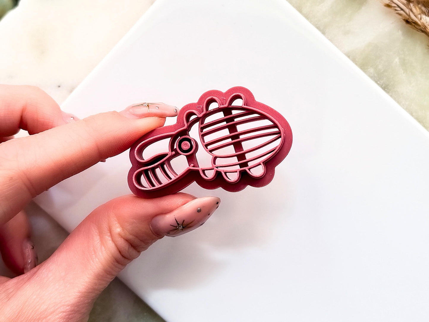 Close up to abstract stag beetle clay cutter showing embossing stamp lines and the support structure to give the cutter strength. 