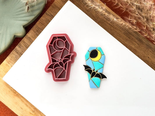 Coffin shaped clay cutter in a stained glass leaded style fearuring a fluing bat and crescent moon. 
