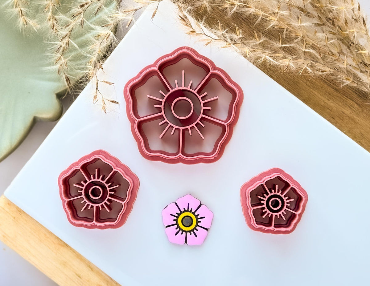 Traditional flower tattoo style polymer clay cutter in different sizes with painted clay cut out sample