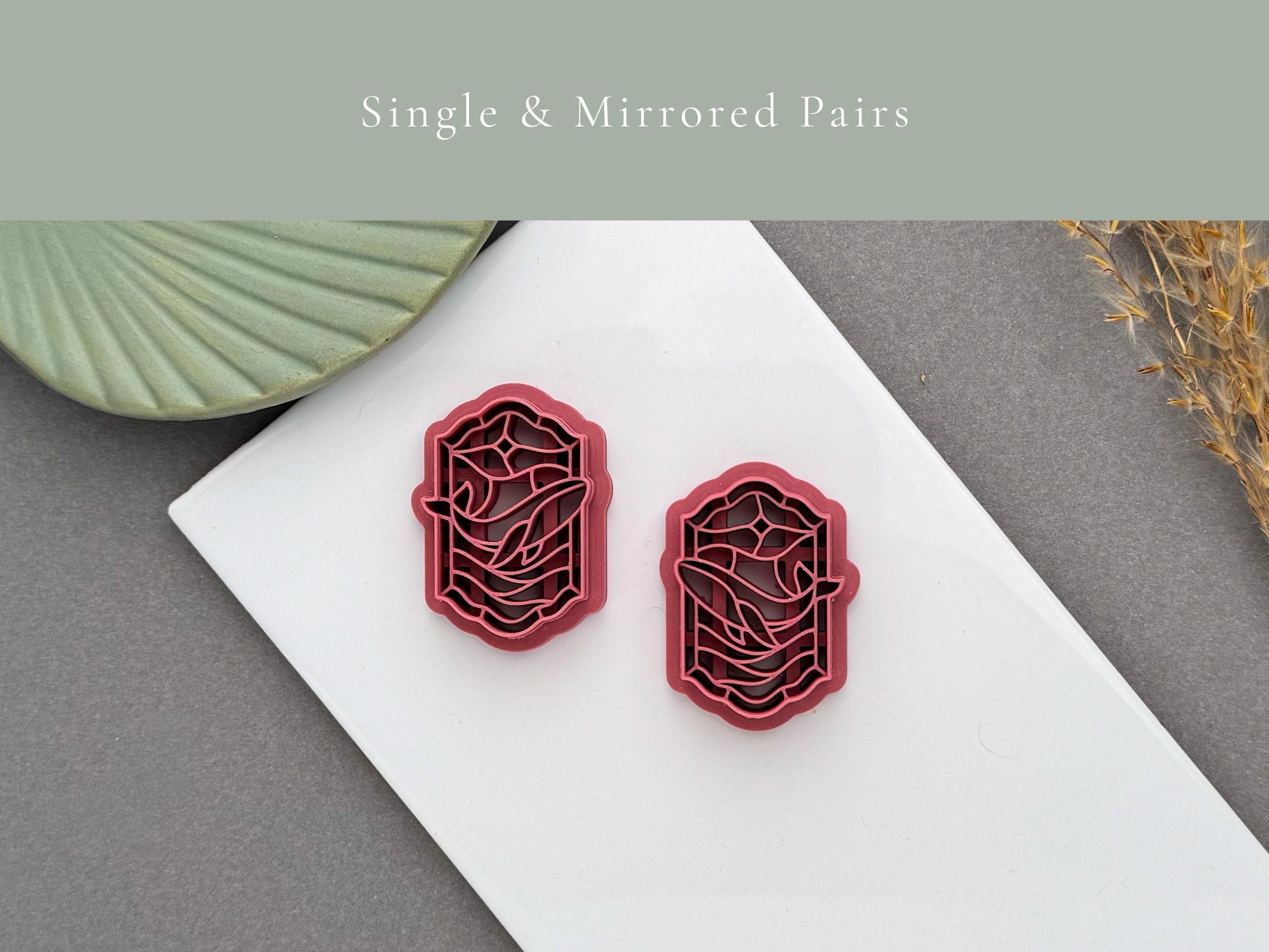 Single and mirrored stained glass whale polymer clay cutters displayed on a white tile for left and right earring designs.